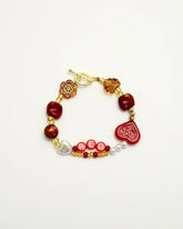 Red-inspired high-end bracelet with heart and amber beads, front view