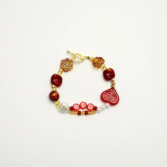 Red-inspired high-end bracelet with heart and amber beads, front view