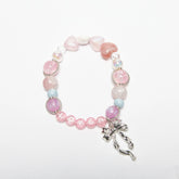 Front view of Lover romantic dreamy bracelet with pink heart-shaped beads and bow charm
