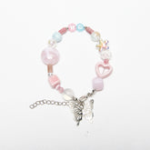 Top view of ME-butterfly bracelet with soft pink tones and “ME” alphabet beads