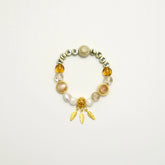 Front view of the Starlit Steps bracelet with FEARLESS letter beads and golden feather charm