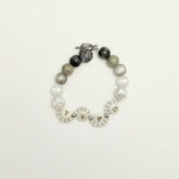 Front view of Tortured Light bracelet featuring TTPD letter beads and silver rose charm