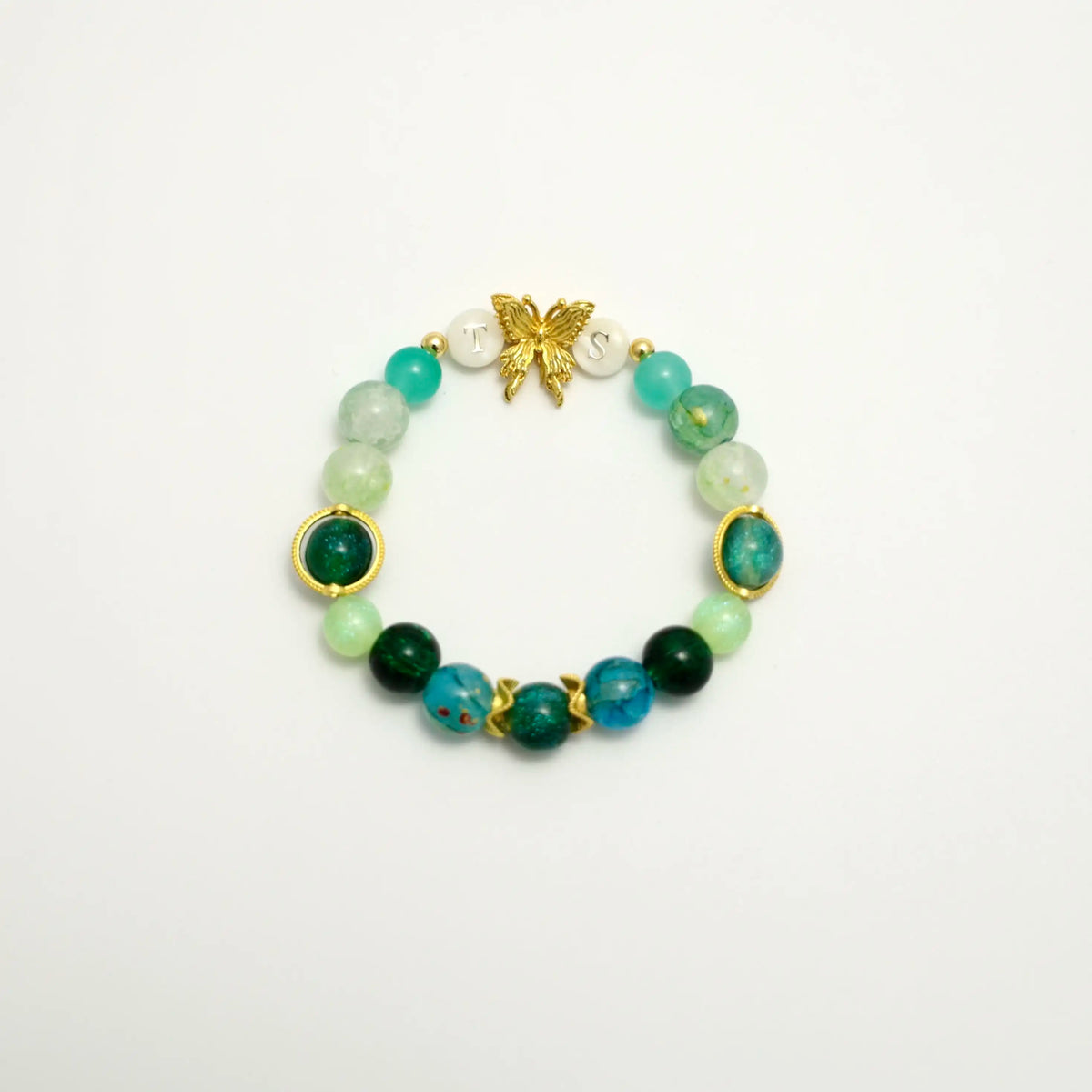 Green beaded bracelet with gold butterfly and TS initials, front view