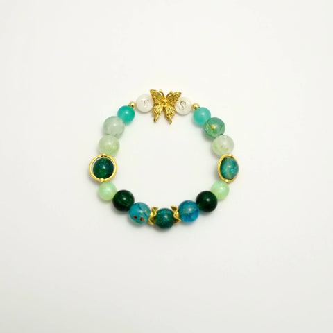 Green beaded bracelet with gold butterfly and TS initials, front view