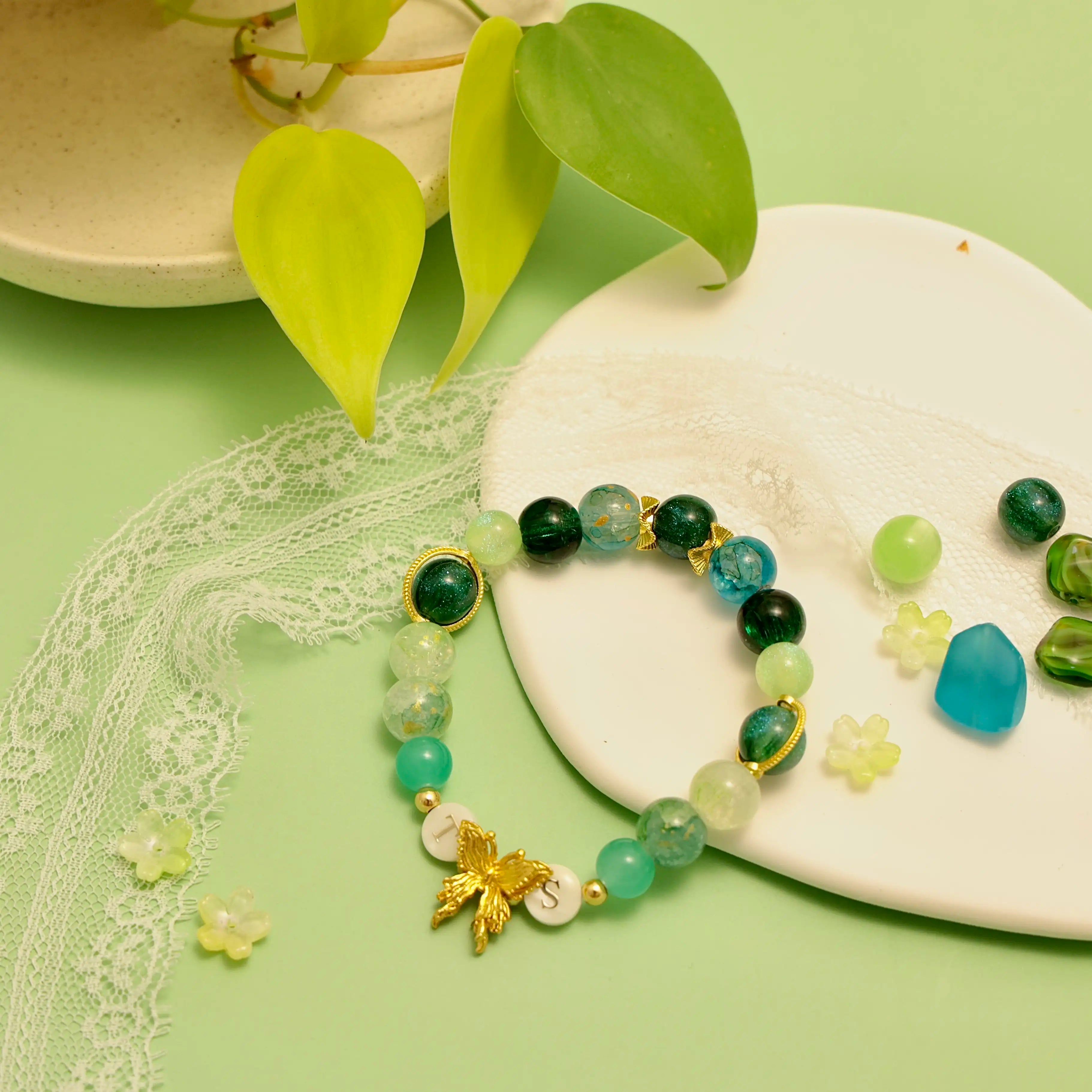Bracelet displayed on white ceramic plate with lace and nature props