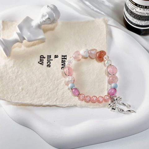 Artistic flat lay of the Lover dreamy bracelet on soft textured background