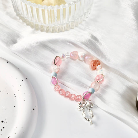 Satin-inspired setup highlighting the charm and details of the Lover bracelet