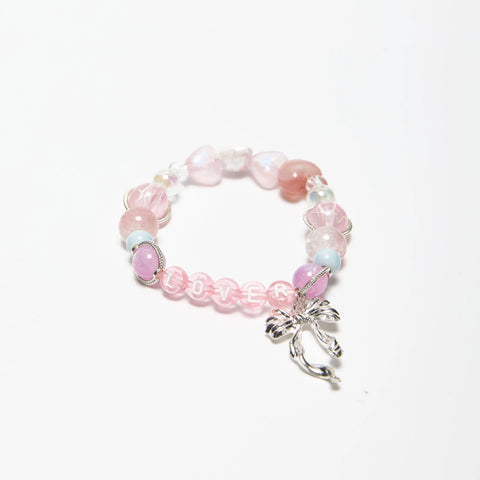 Top-down look at Lover bracelet featuring soft pink tones and delicate beading