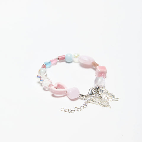 Side view of ME-butterfly dreamy bracelet with pink heart and butterfly charm