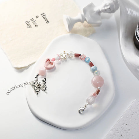 Close-up of ME-butterfly bracelet with detailed pink beads and transparent accents