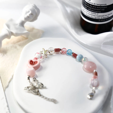 ME-butterfly bracelet arranged with sculptural decor and butterfly charm in focus