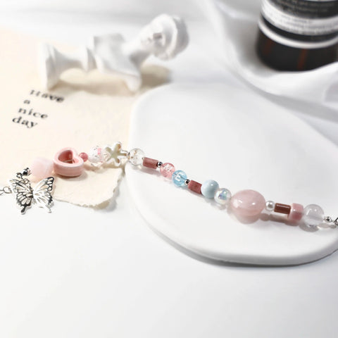 Full layout of ME-butterfly bracelet showing silver charm and colorful pastel beads