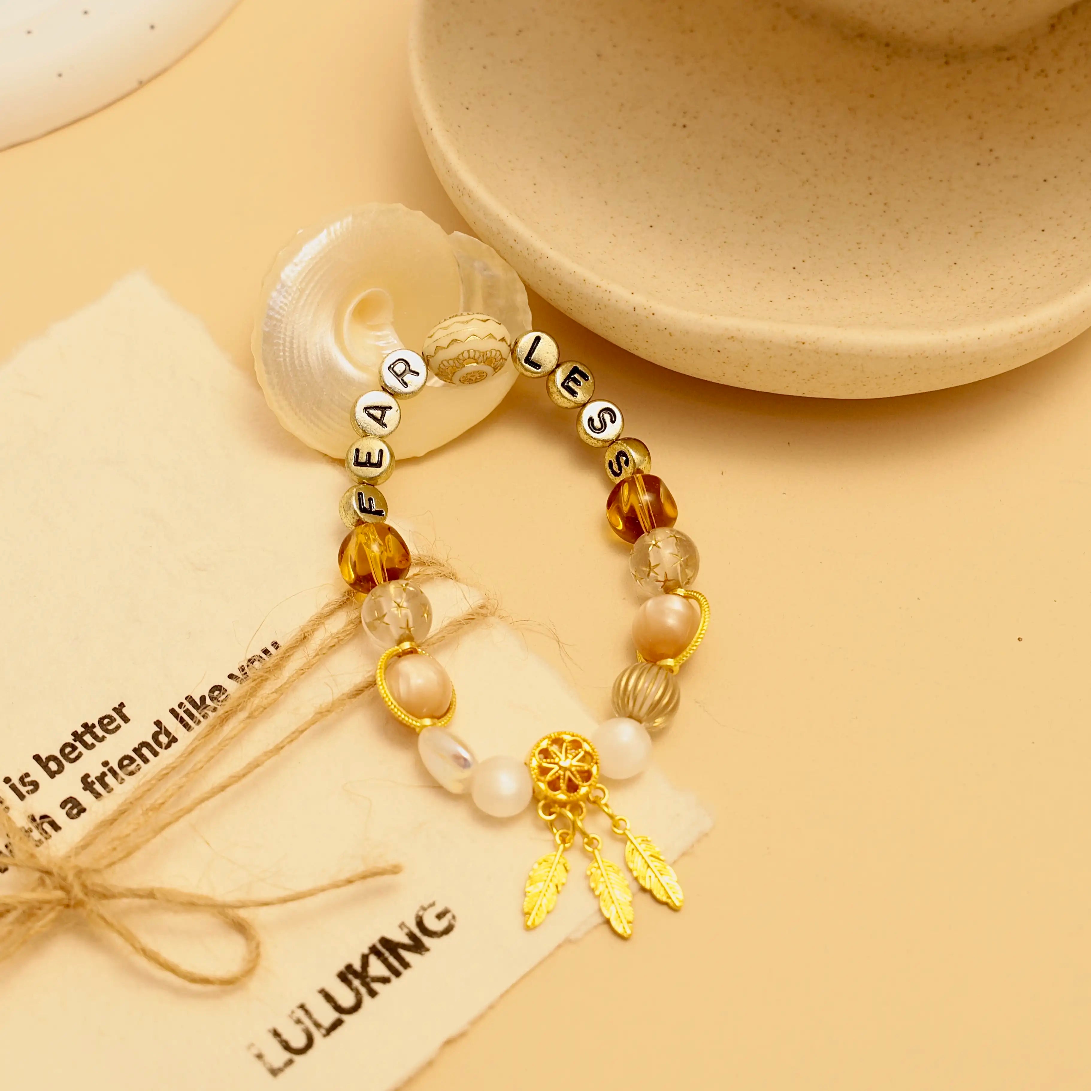 Close-up of Starlit Steps bracelet surrounded by beige background and seashell props