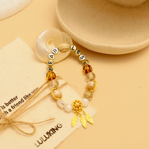 Close-up of Starlit Steps bracelet surrounded by beige background and seashell props