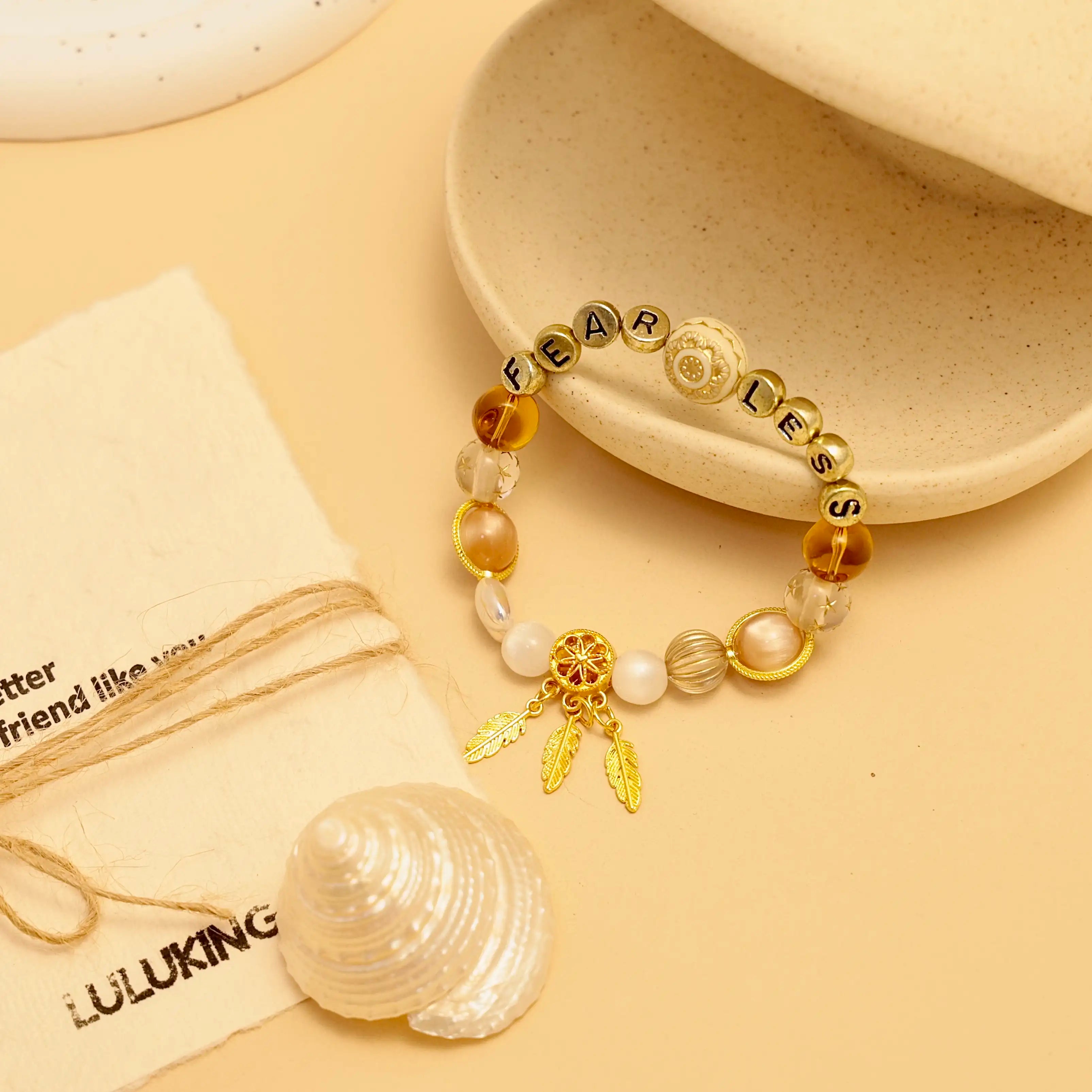 Display of the bracelet resting beside a clam shell and brand linen pouch