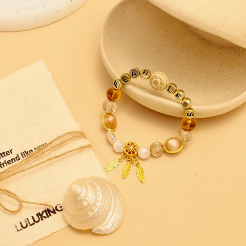 Display of the bracelet resting beside a clam shell and brand linen pouch