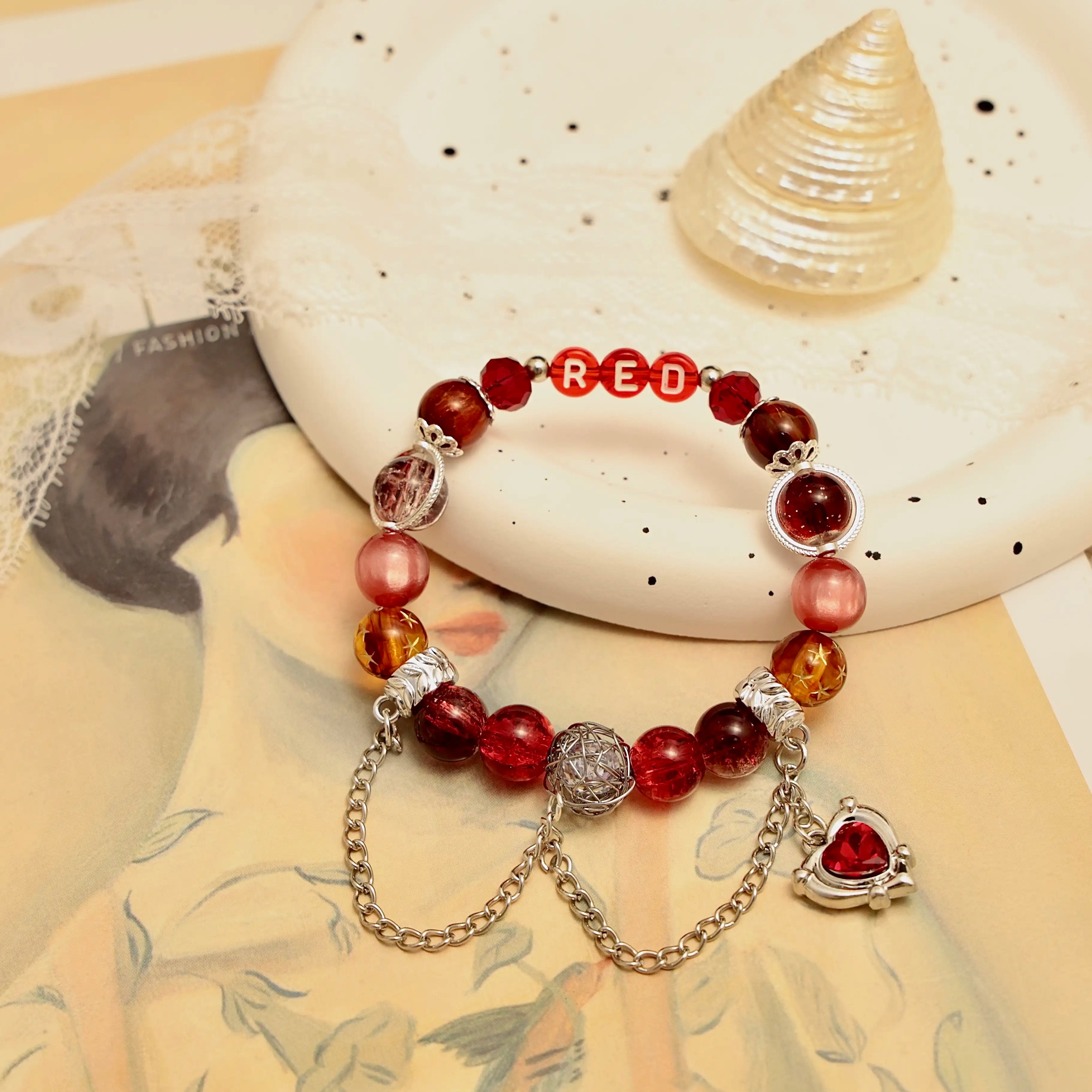 Display image with vintage painting and red beaded bracelet