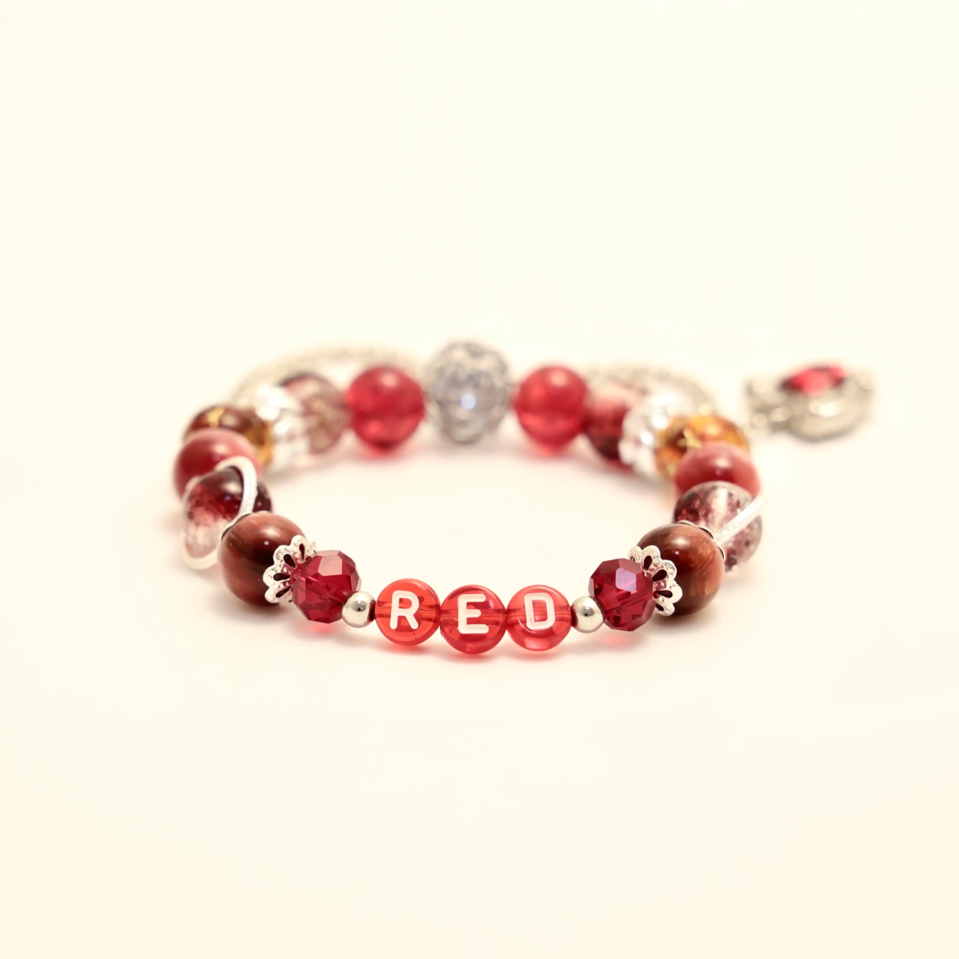 Close-up of RED lettering beads and blush tones on bracelet