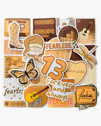 Gold and yellow stickers inspired by the Fearless era, including the number 13, disco ball, and lyrics motifs.