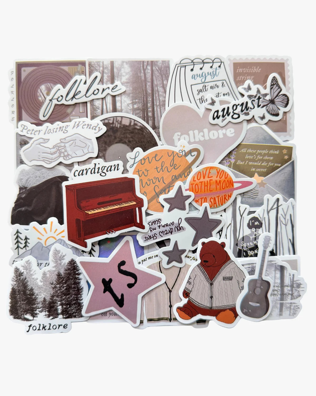 Cottagecore grey stickers inspired by the folklore era, with cardigan, pine trees, and mirrorball designs.
