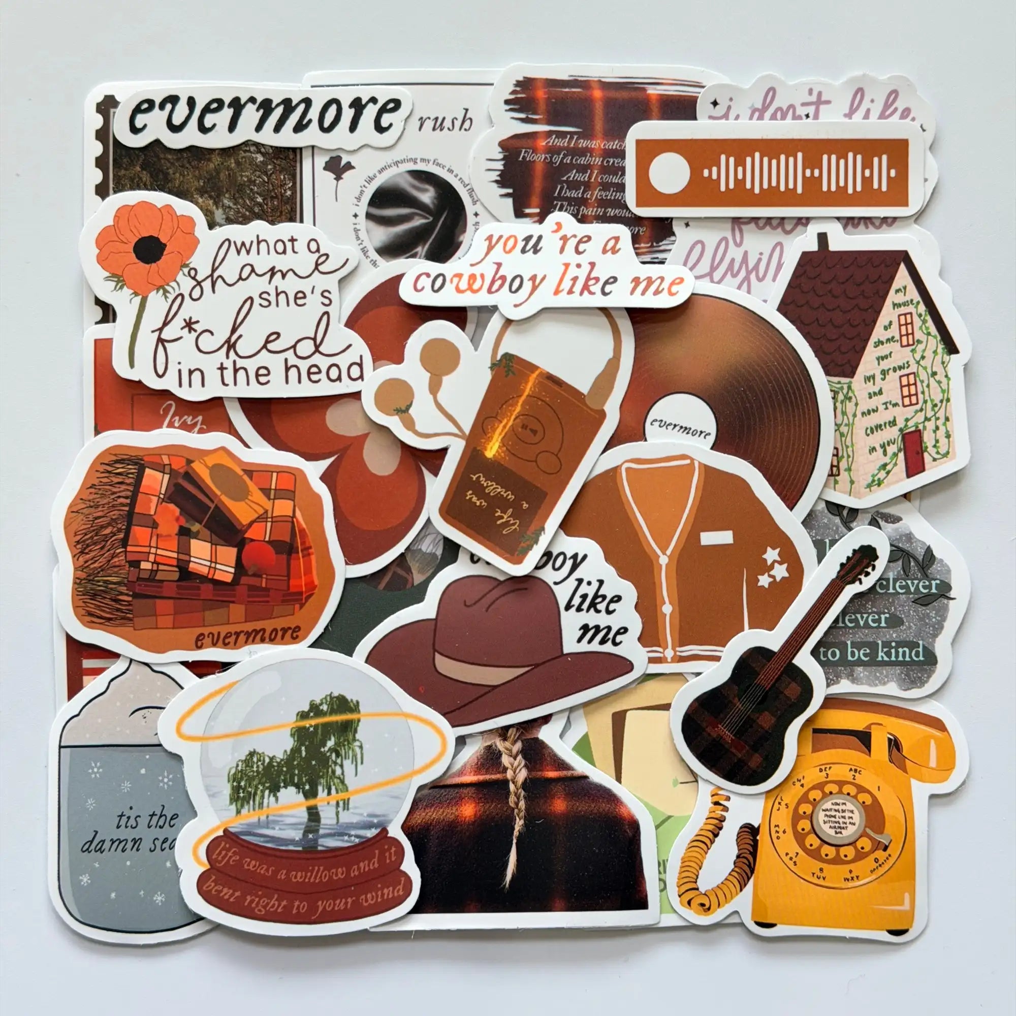 Taylor Swift inspired evermore Swiftie stickers bundle with 50 different fan-made designs, warm autumn colors, storytelling visuals and cozy album mood
