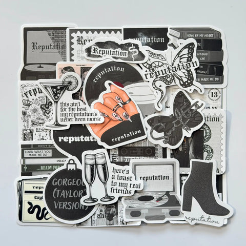 Taylor Swift inspired Reputation Swiftie stickers bundle featuring 50 unique fan-made designs, black and grey tones, edgy snakes and bold album aesthetics
