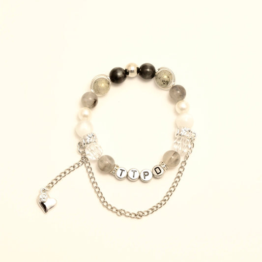 TTPD bracelet with letter beads and silver chain heart charm, front close-up
